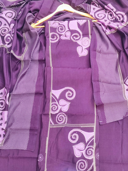 Close-up of lilac swirl and leaf print on deep plum muslin
