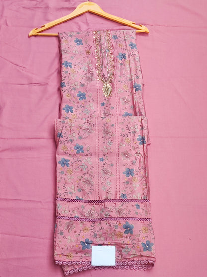 Close-up of gold beadwork, sequin and pearl handwork on pink muslin neckline