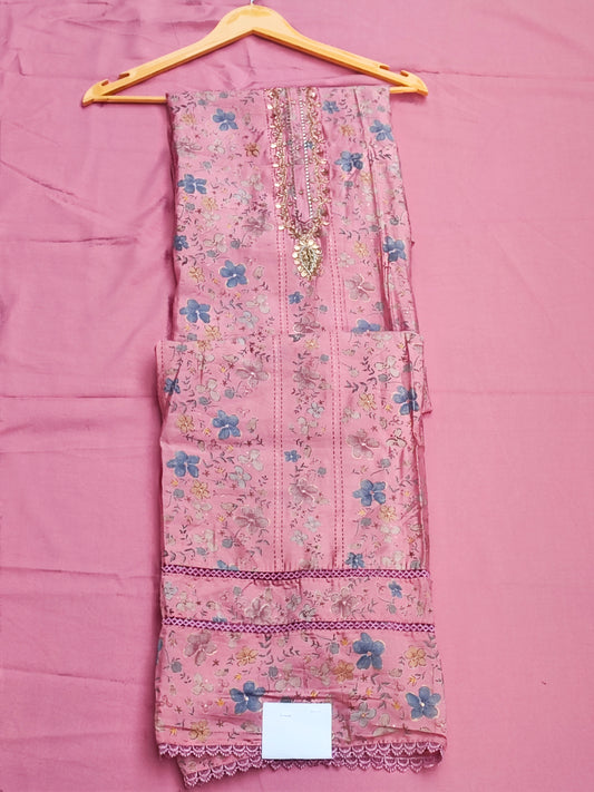 Close-up of gold beadwork, sequin and pearl handwork on pink muslin neckline