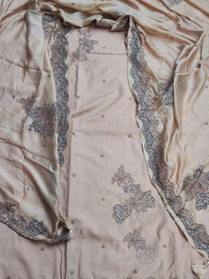 Handmade tassel hanging on corner of beige tabby silk dupatta