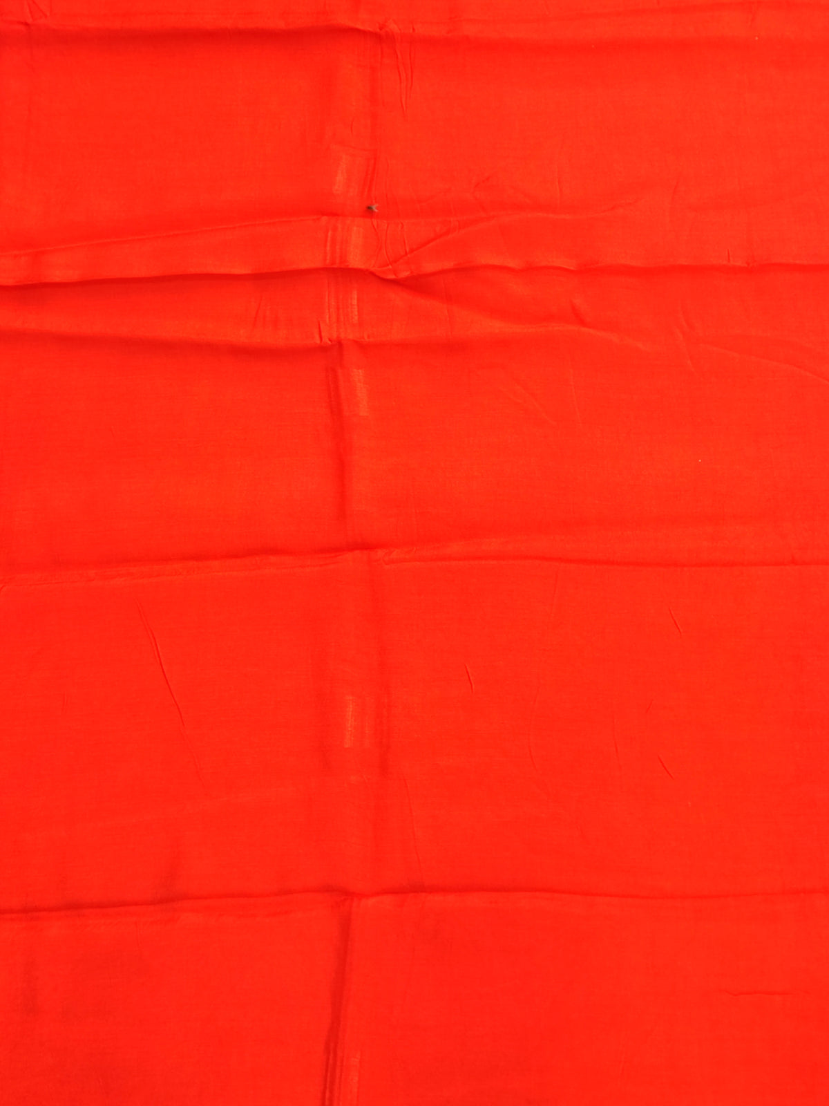 Bandhani tie-dye detail in bright orange with white dots