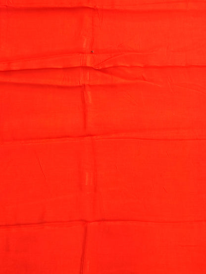 Bandhani tie-dye detail in bright orange with white dots