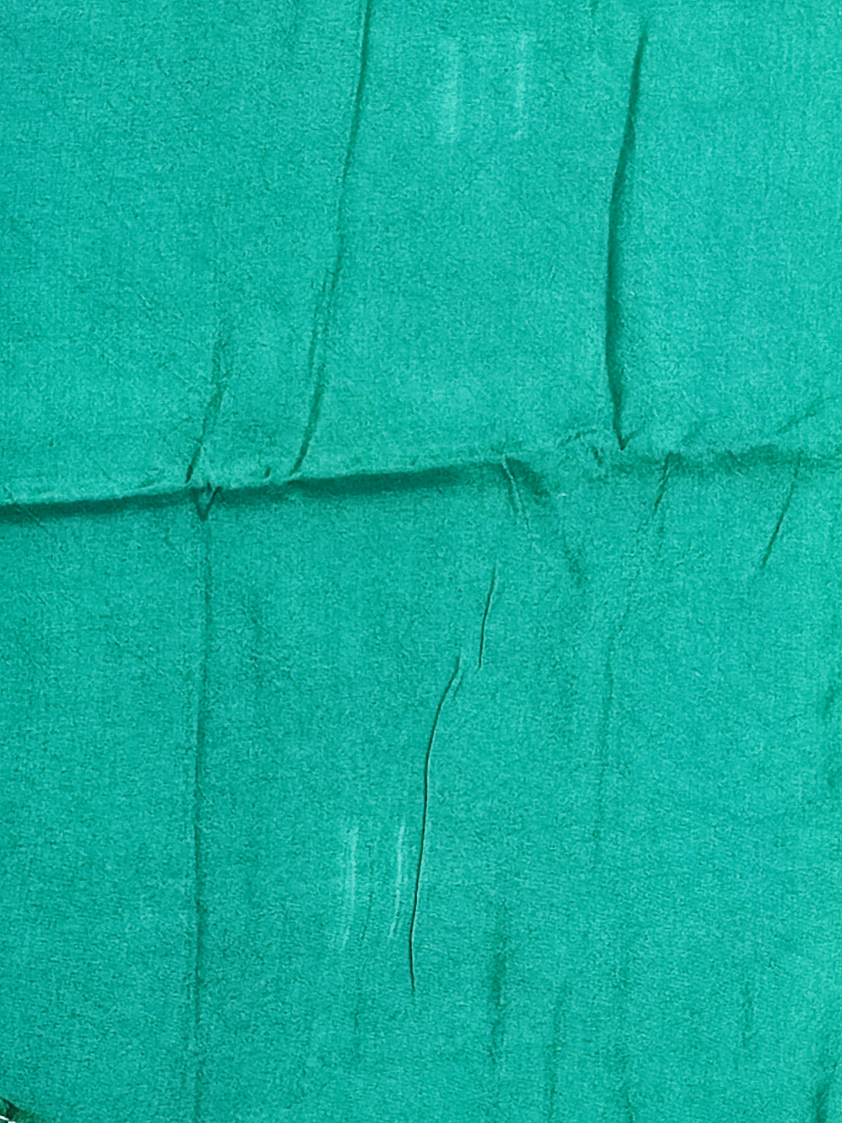 Bandhani tie-dye detail in bottle green with white and pale blue dots