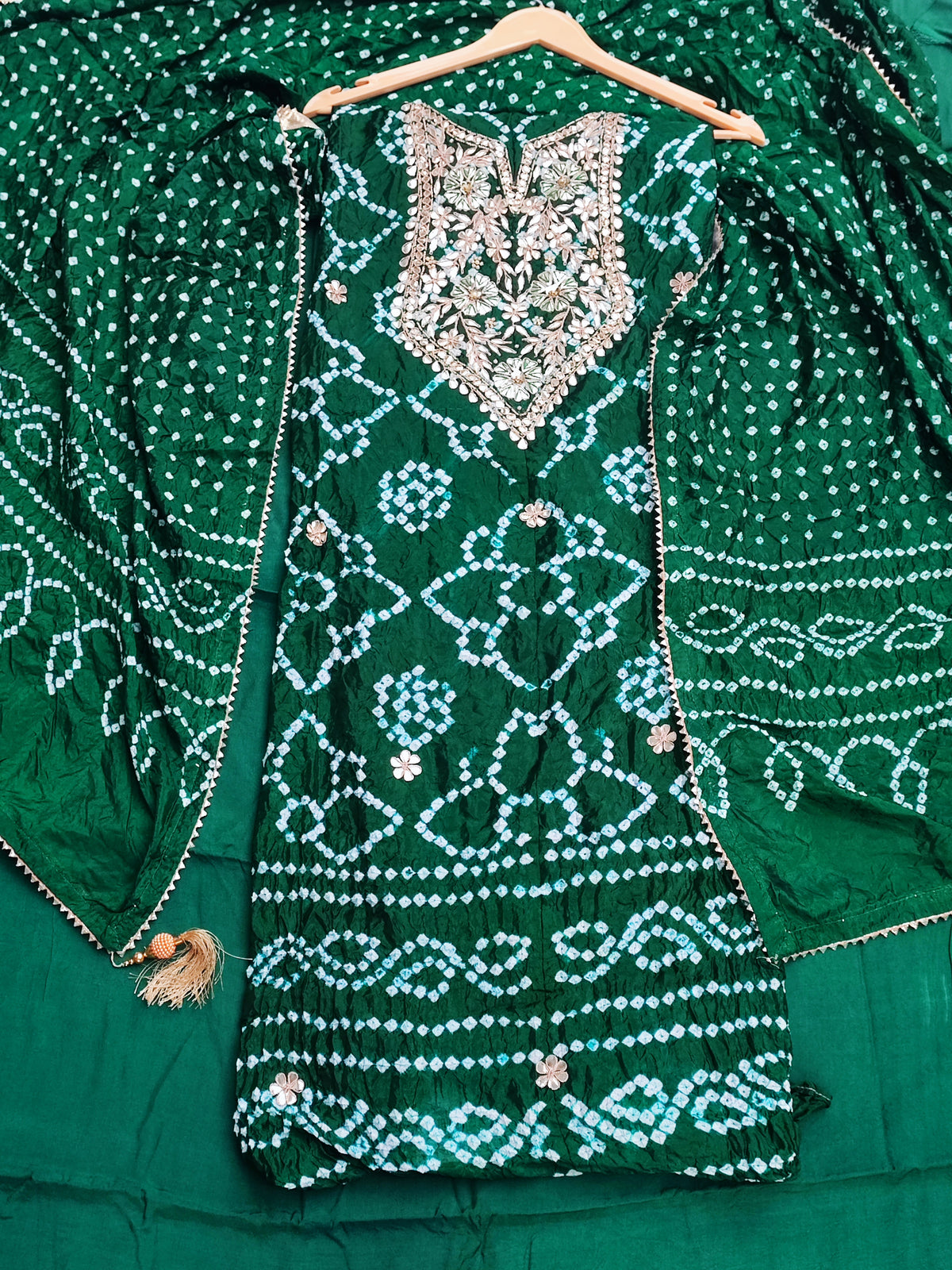 Close-up of gota patti neckline with pearl clusters on bottle green bandhani