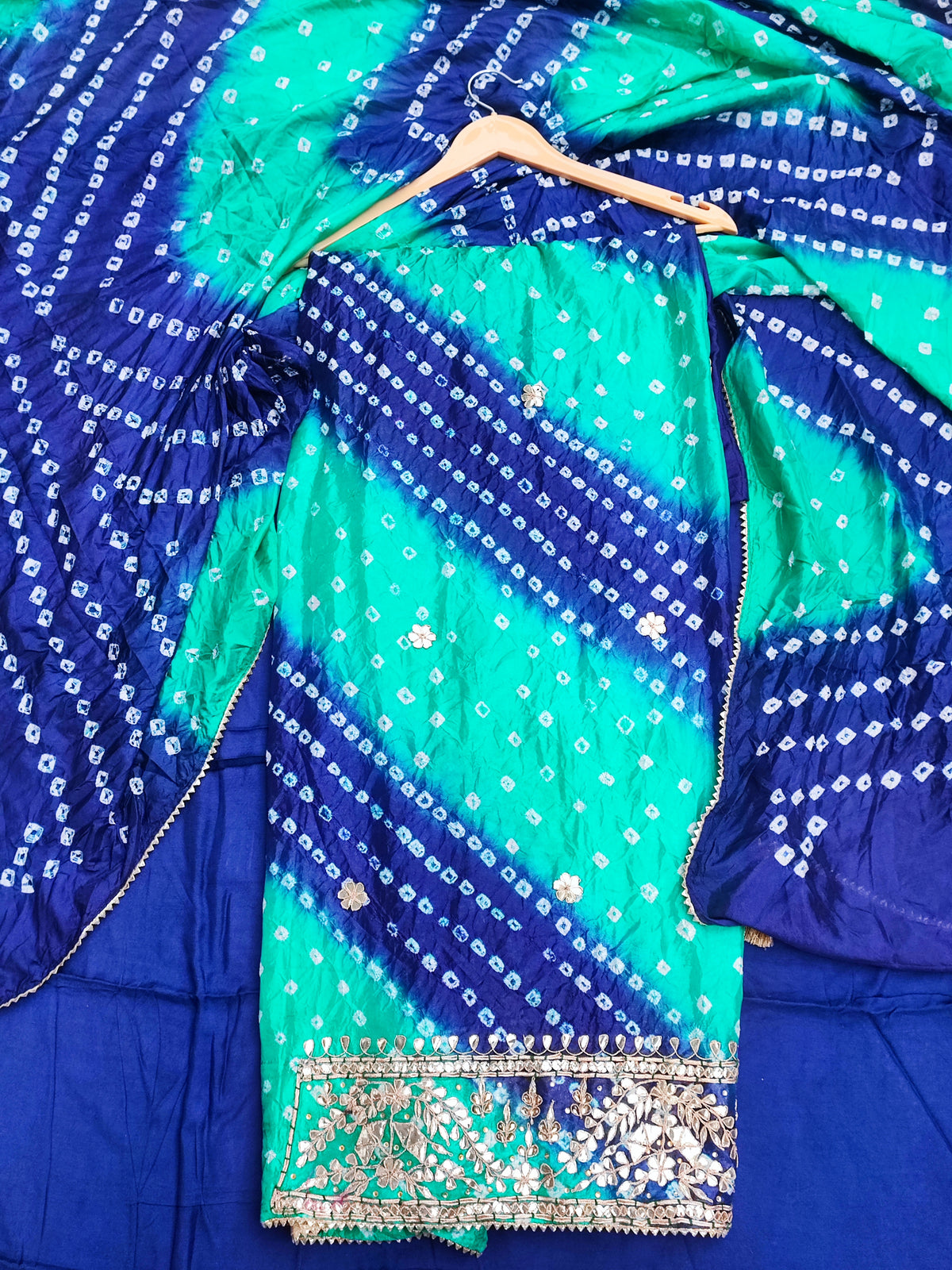 Close-up of gota patti ghera border on rama green bandhani shirt hem
