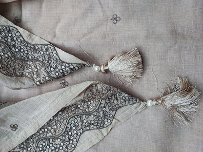 Close-up of tonal thread embroidery and sippi work on beige linen